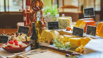 A cheese board with various types of cheese, crackers, and a bottle of wine.