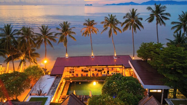 A resort with a pool, palm trees, and a view of the sea. - The Sea Koh Samui Resort & Residences by Tolani (Koh Samui)