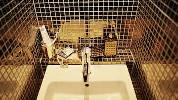 A sink with a faucet, surrounded by a metal grid.