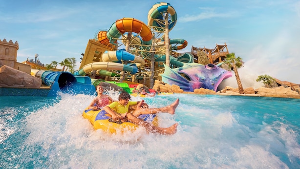 A water park with multiple water slides and a pool area.