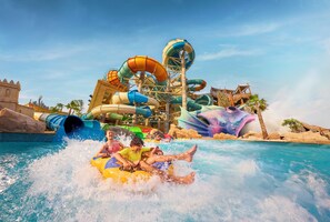 A water park with multiple water slides and a pool area. - Yas Plaza Mangroves (Abu Dhabi)