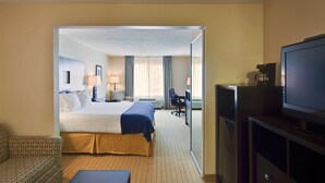 A hotel room with a bed, a desk, a chair, a television, and a coffee maker. - Holiday Inn Express Hotel & Suites Albuquerque Airport by IHG (Albuquerque)