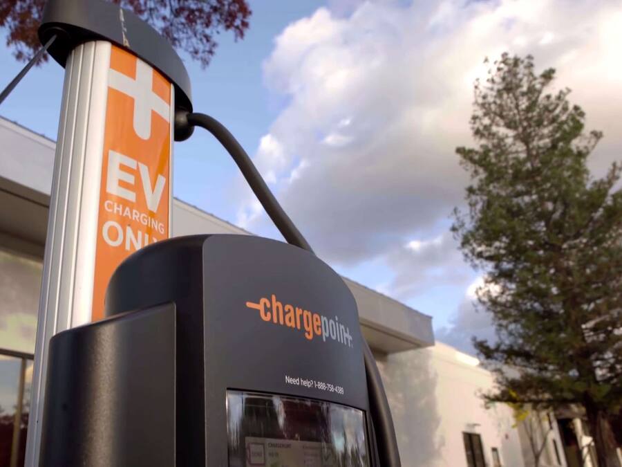 An electric vehicle charging station with a sign indicating it is for EV charging only.