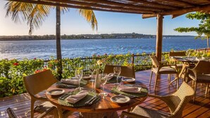 A table set for dining with a view of the water.