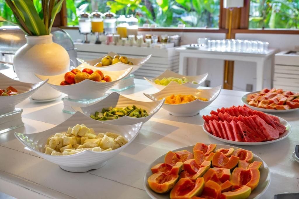 A buffet with various fruits and vegetables.