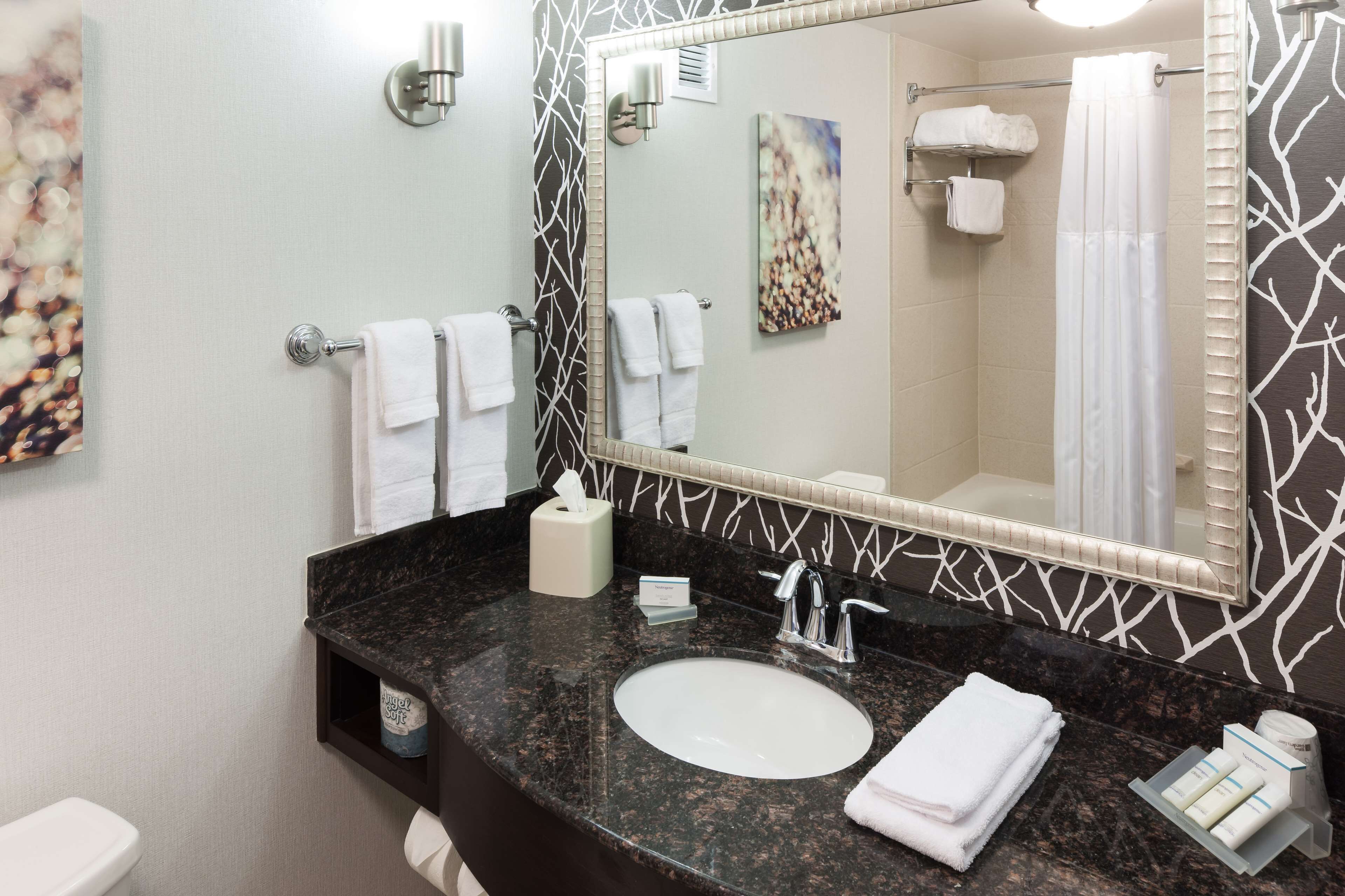 combined shower/bathtub, designer toiletries, hair dryer, towels