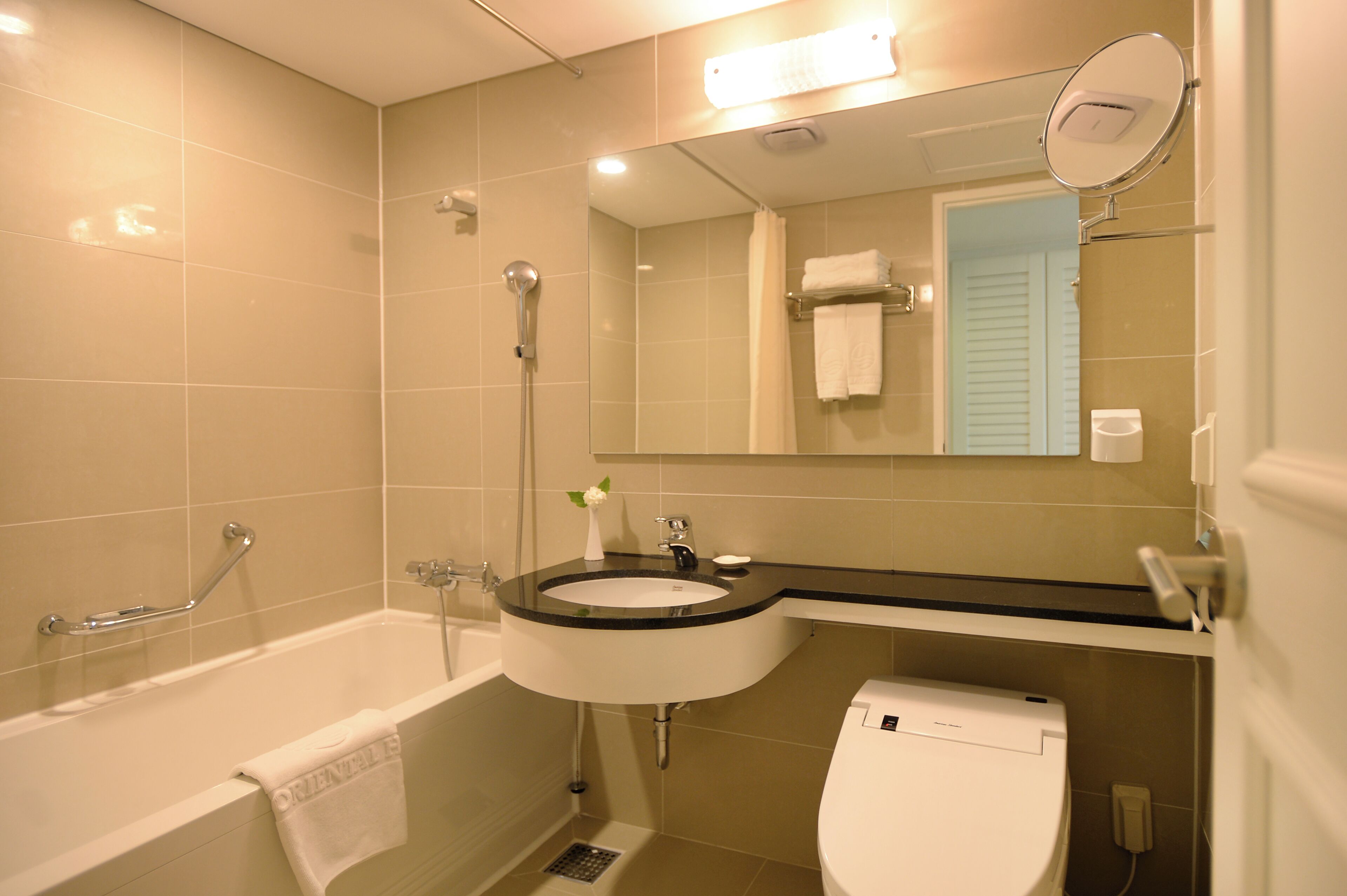 A bathroom with a bathtub, sink, and toilet.