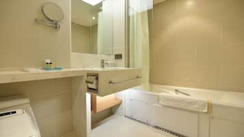 A modern bathroom with a toilet, sink, and bathtub.