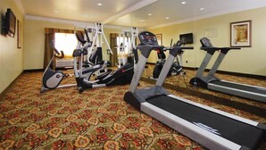 A hotel fitness center with treadmills, elliptical machines, and weight equipment. - Best Western Cresson Inn (Cresson)