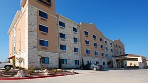 A Best Western hotel with a stone facade, multiple windows, and a parking lot. - Best Western Cresson Inn (Cresson)