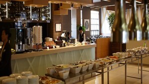 A buffet setup with various food items and a coffee machine. - Holiday Inn Alpensia Pyeongchang Suites by IHG (Pyeongchang)