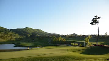 Surrounded by lush greenery and a serene lake, this golf course offers a tranquil setting for a round of golf.