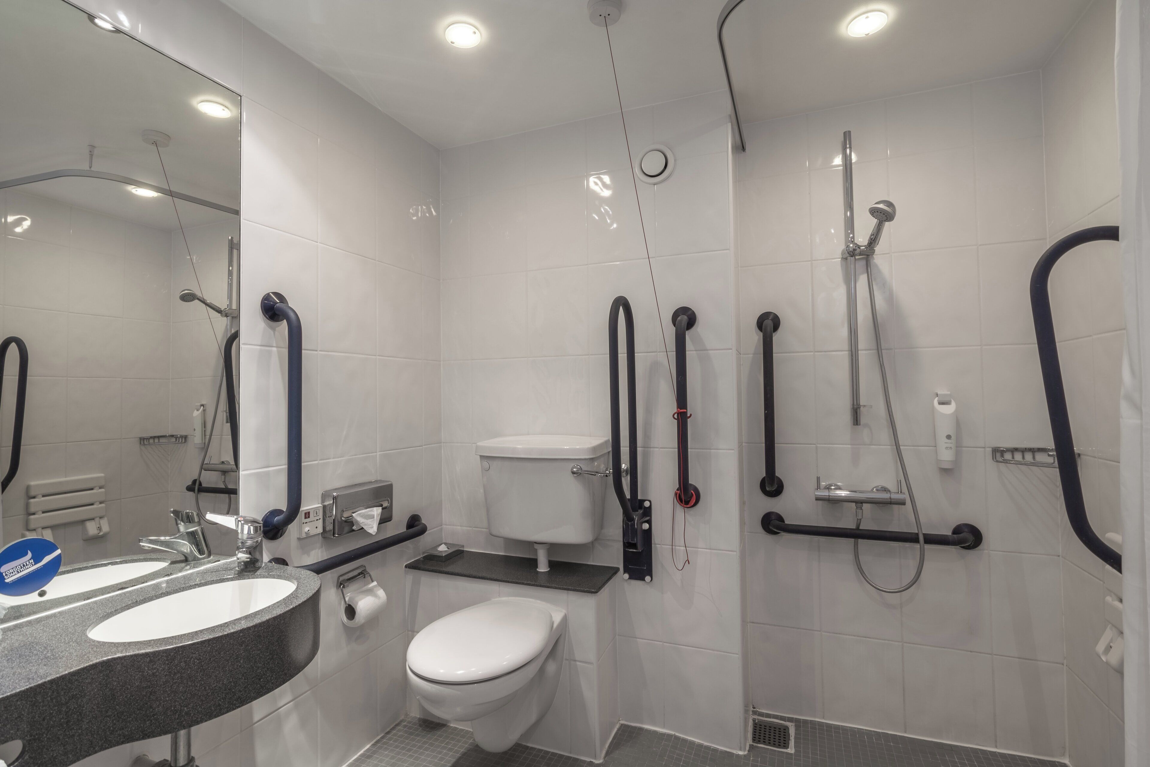 A modern bathroom with a toilet, bidet, and shower.