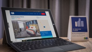 A laptop displaying a hotel booking page for Holiday Inn Express Kettering, with a 4.5-star rating and a price of 62.40 GBP per night. - Holiday Inn Express Kettering by IHG (Kettering)
