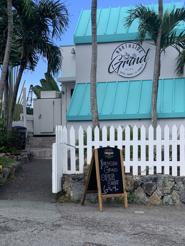 A building with a sign that reads "Northside Grind" and a chalkboard sign indicating it's open daily from 6:30 AM to 4 PM. - Flamboyan on the Bay Resort and Villas (St. Thomas)
