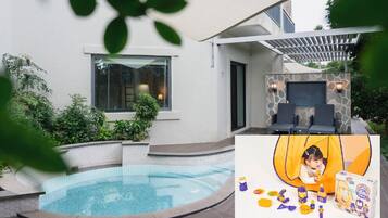 Relax by the pool surrounded by a low wall and shaded by a pergola.