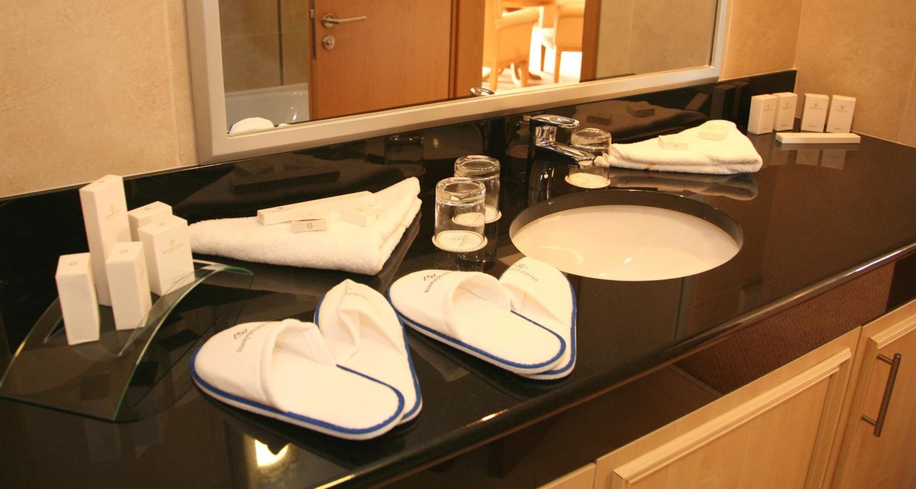 designer toiletries, hair dryer, towels