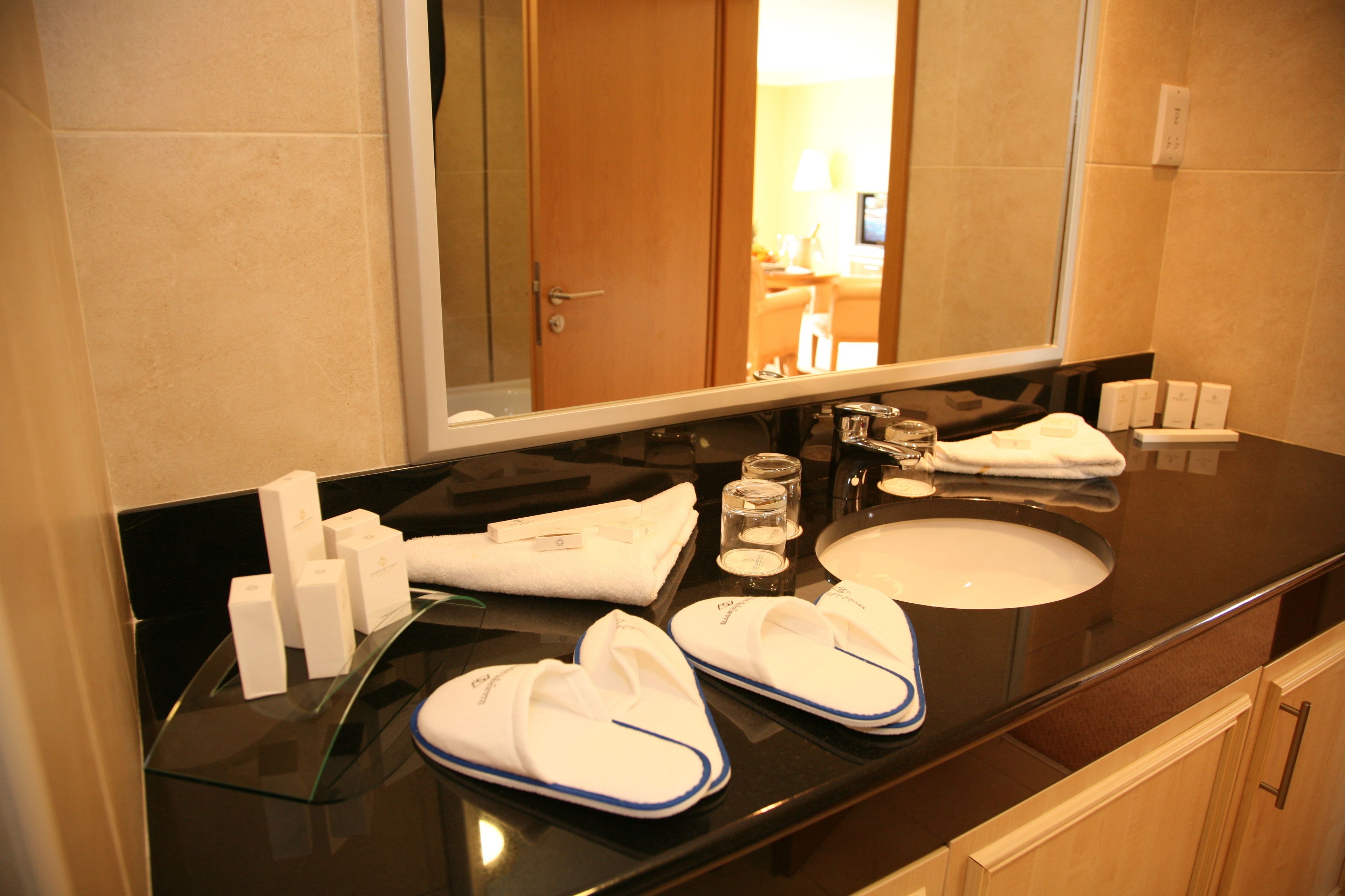 designer toiletries, hair dryer, towels