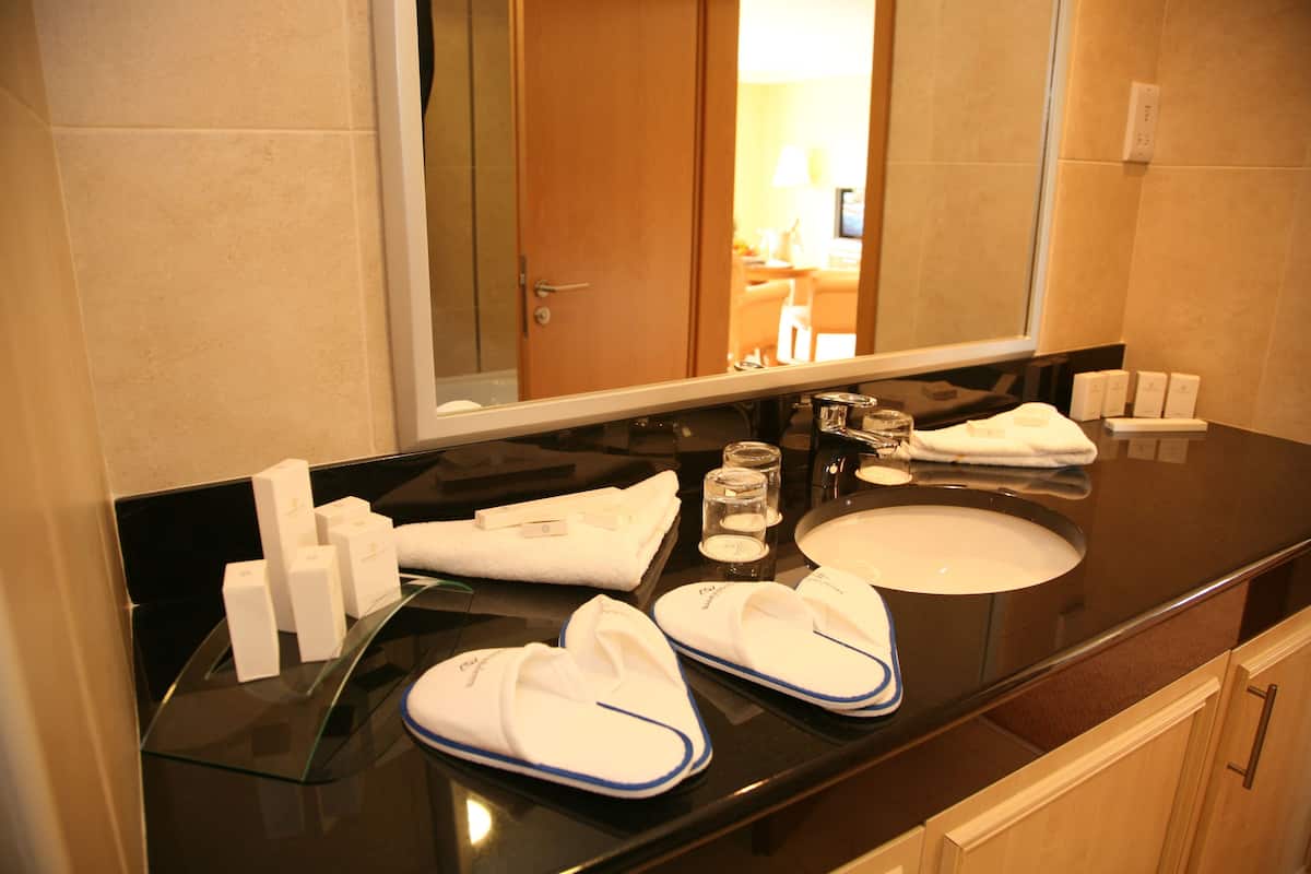 designer toiletries, hair dryer, towels