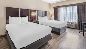A hotel room with two beds, a desk, and a window with curtains. - Best Western Plus Eastgate Inn & Suites (Wichita)