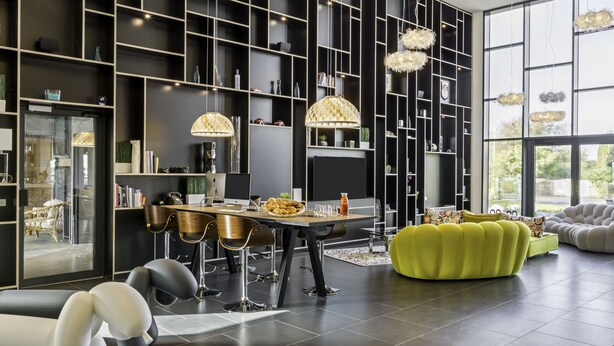 A modern living room with a dining area, featuring a black and white color scheme, large windows, and contemporary furniture. - Best Western Plus Europe Hotel (Brest)