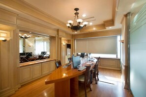 A conference room with a long table, multiple chairs, and a large screen. - Libero Hotel (Busan)