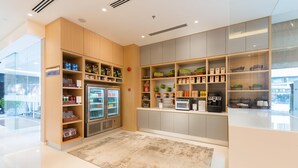A self-service kiosk with refrigerated drinks, snacks, and a coffee machine. - Hilton Garden Inn Kuala Lumpur Jalan Tuanku Abdul Rahman North (Kuala Lumpur)
