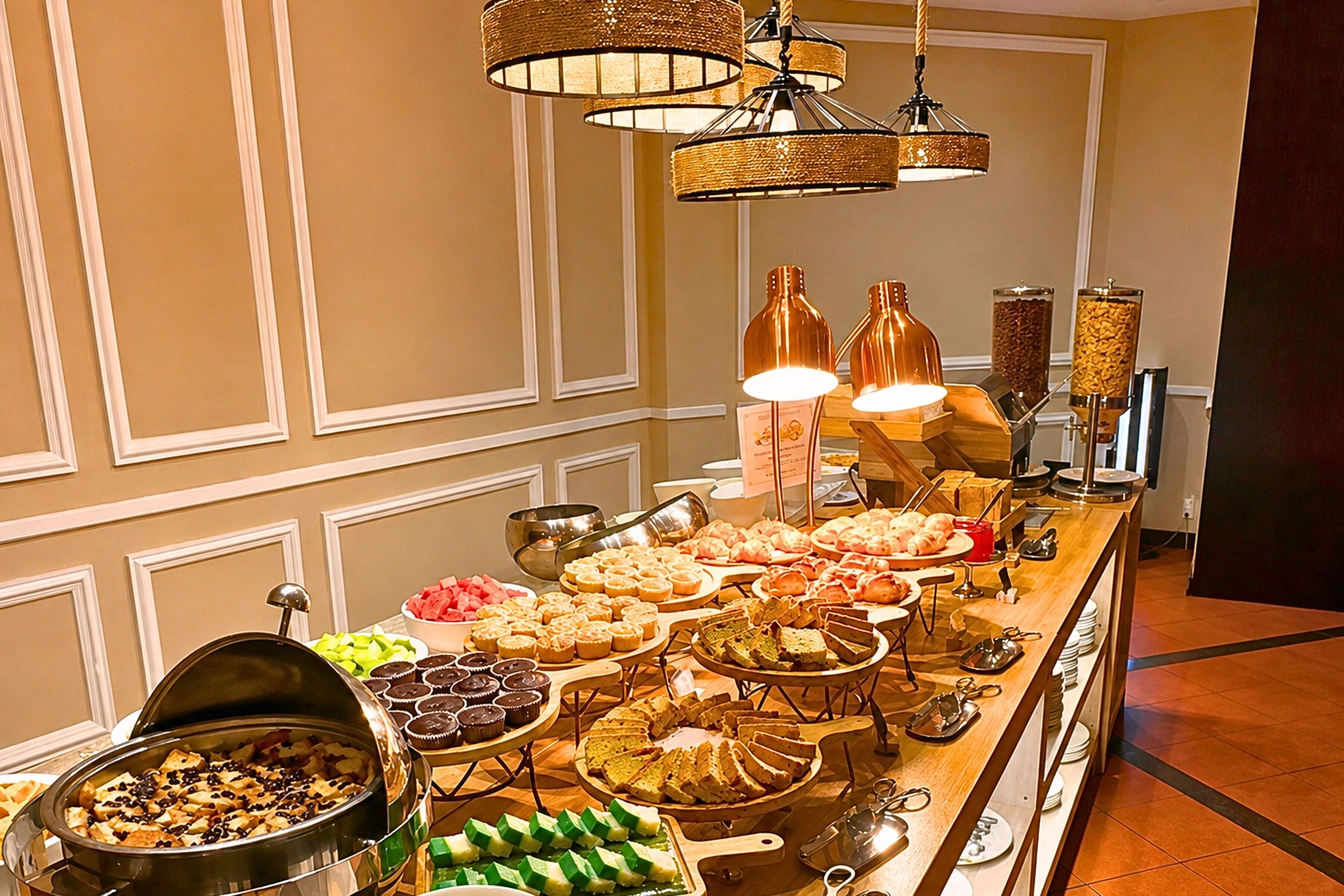 A buffet with various food items and a coffee station.