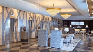 A modern lobby with a checkered floor, grey sofas, and a chandelier. - Howard Johnson By Wyndham Kuala Lumpur 118 (Kuala Lumpur)
