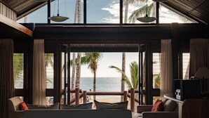 A room with a view of the beach, large windows, and a wooden ceiling. - Sinalei Reef Resort & Spa (Siumu)