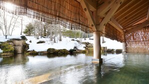 A tranquil indoor water feature with a wooden ceiling and stone surroundings. - Shizukuishi Prince Hotel (Shizukuishi)