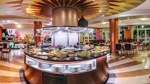 A buffet area with a central serving station, surrounded by dining tables and chairs. - Golden Carthage Residence (La Marsa)