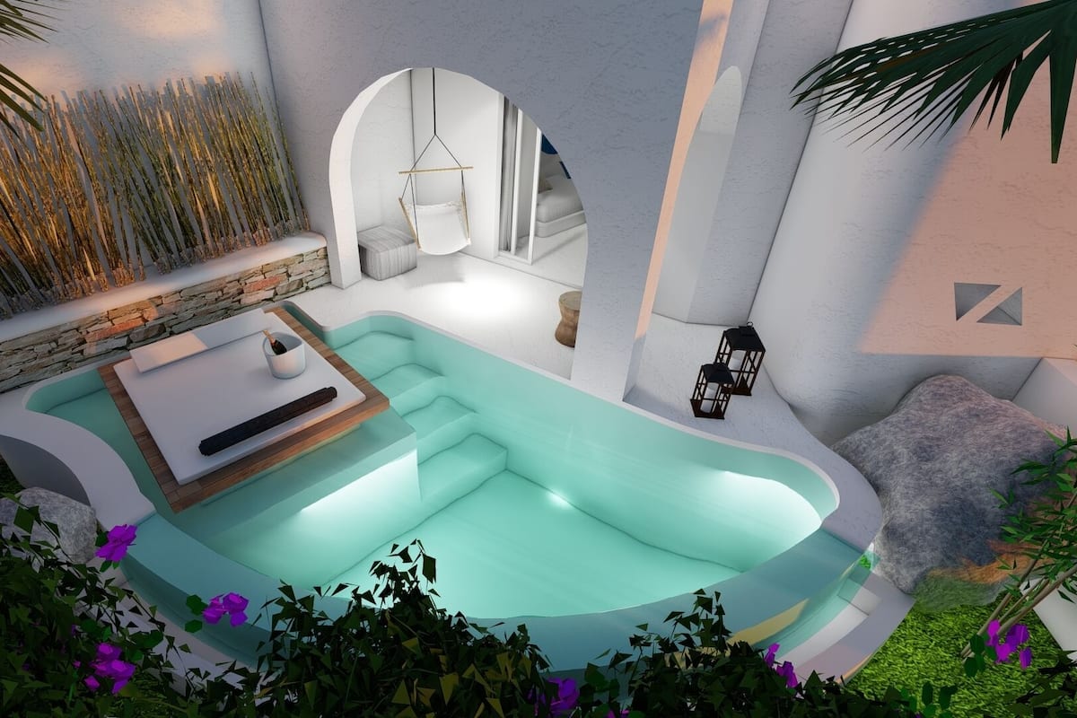 A modern pool area with a built-in seating area, stone wall, and hanging lanterns.