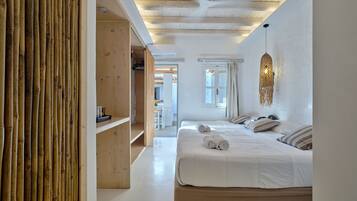 A modern bedroom with a large bed, wooden shelves, and a ceiling fan.