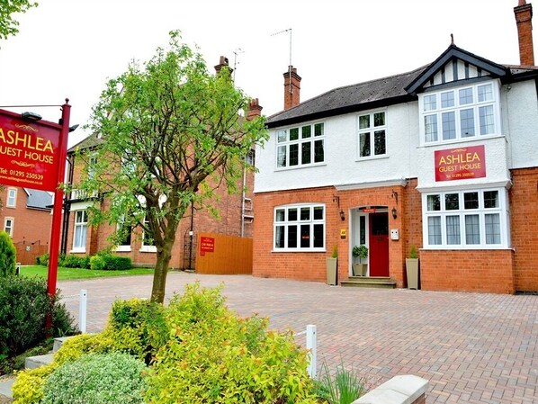 A two-story building with a red and white facade, labeled as "Ashlea Guest House." - Ashlea Guest House (Banbury)
