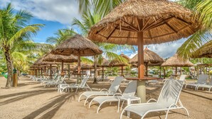 A beach with thatched umbrellas and white lounge chairs. - Salinas Maragogi All Inclusive Resort (Maragogi)