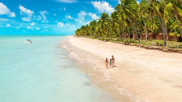 On the beach, white sand, free beach cabanas, sun loungers