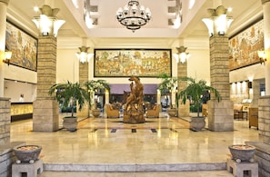 Experience the grandeur of our lobby, featuring a central fountain, ornate paintings, and elegant seating areas.