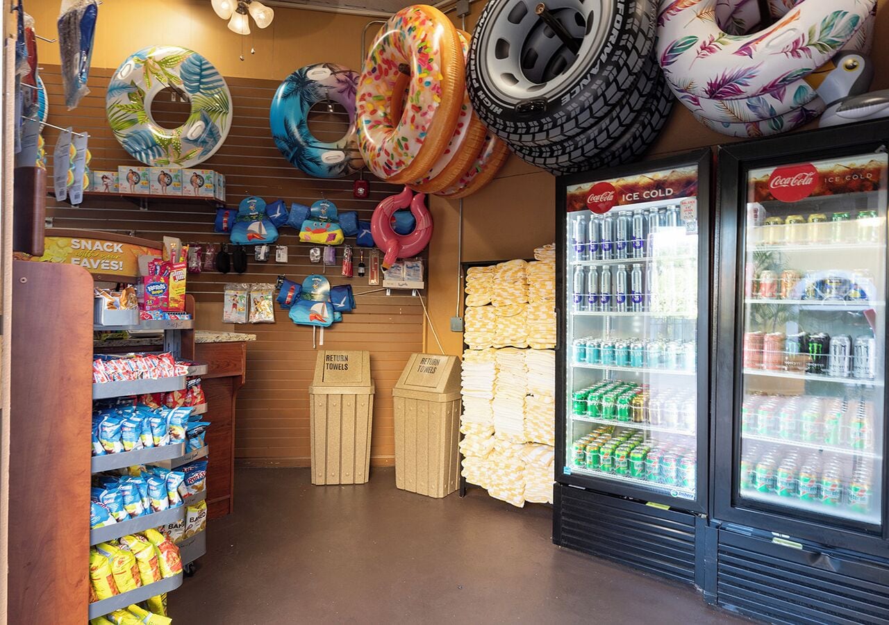 A store with snack aisles, a return towels bin, and beverage coolers.