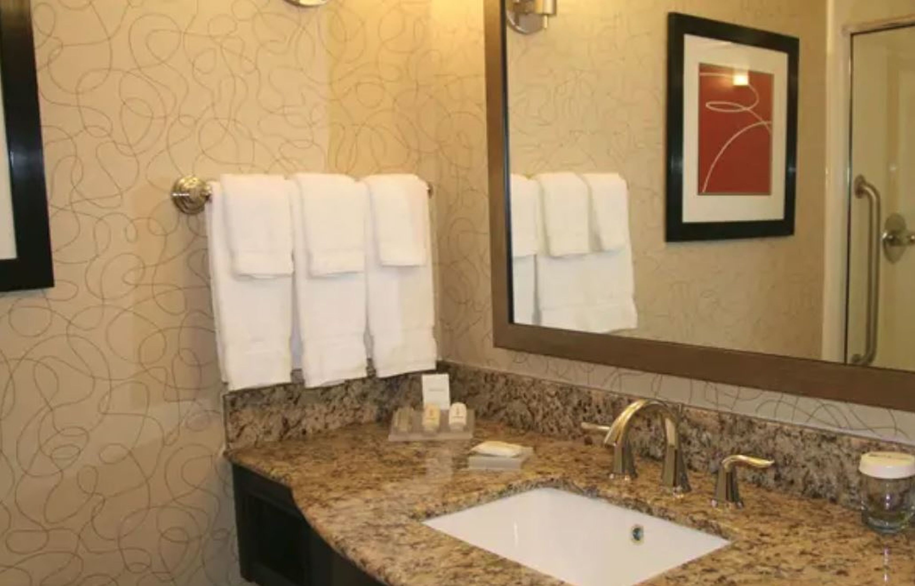 combined shower/bathtub, designer toiletries, hair dryer, towels