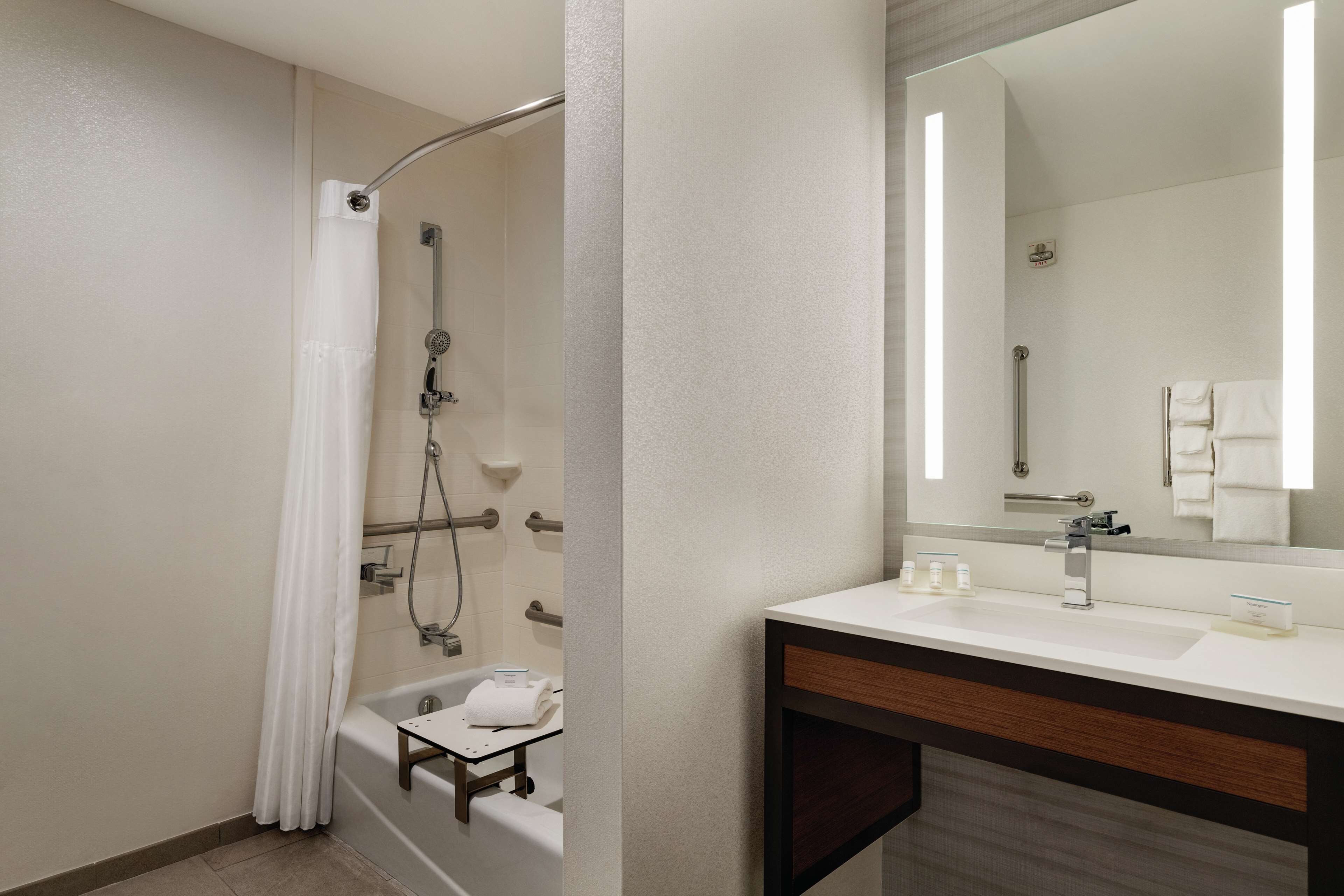 combined shower/bathtub, designer toiletries, hair dryer, towels