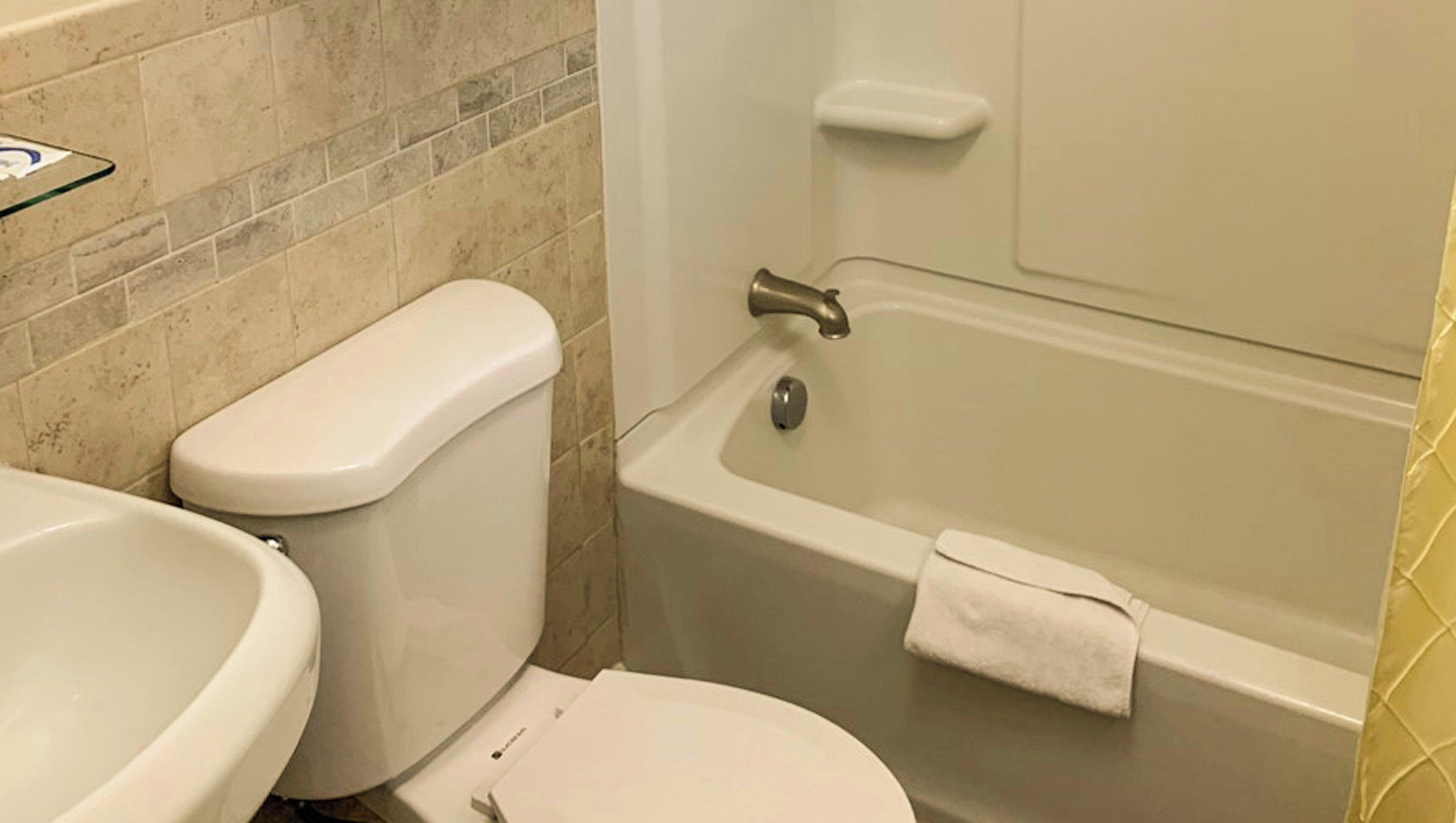 Ein Badezimmer mit Toilette, Waschbecken und Badewanne.