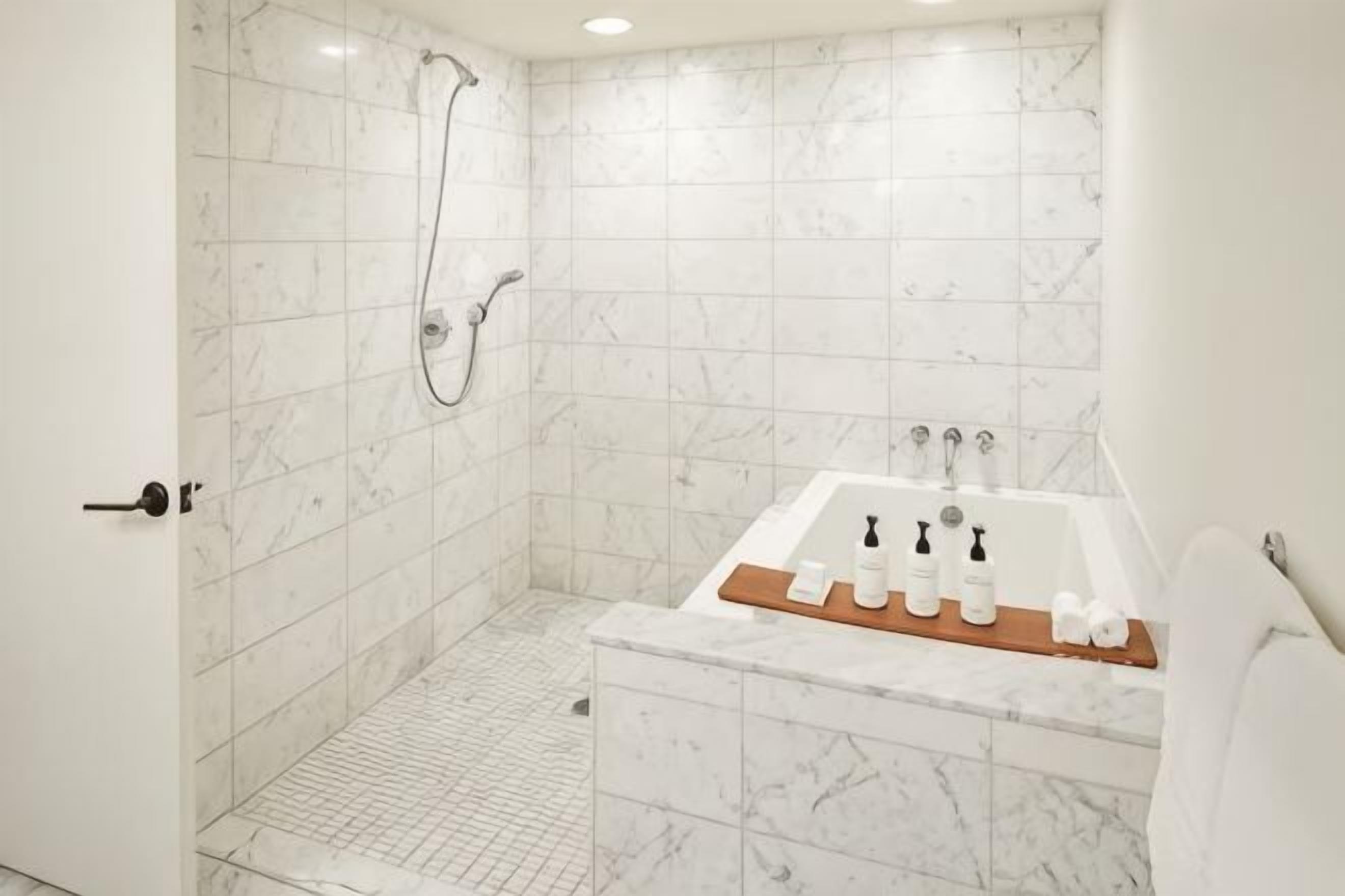 Deep soaking tub, rainfall showerhead, designer toiletries, hair dryer