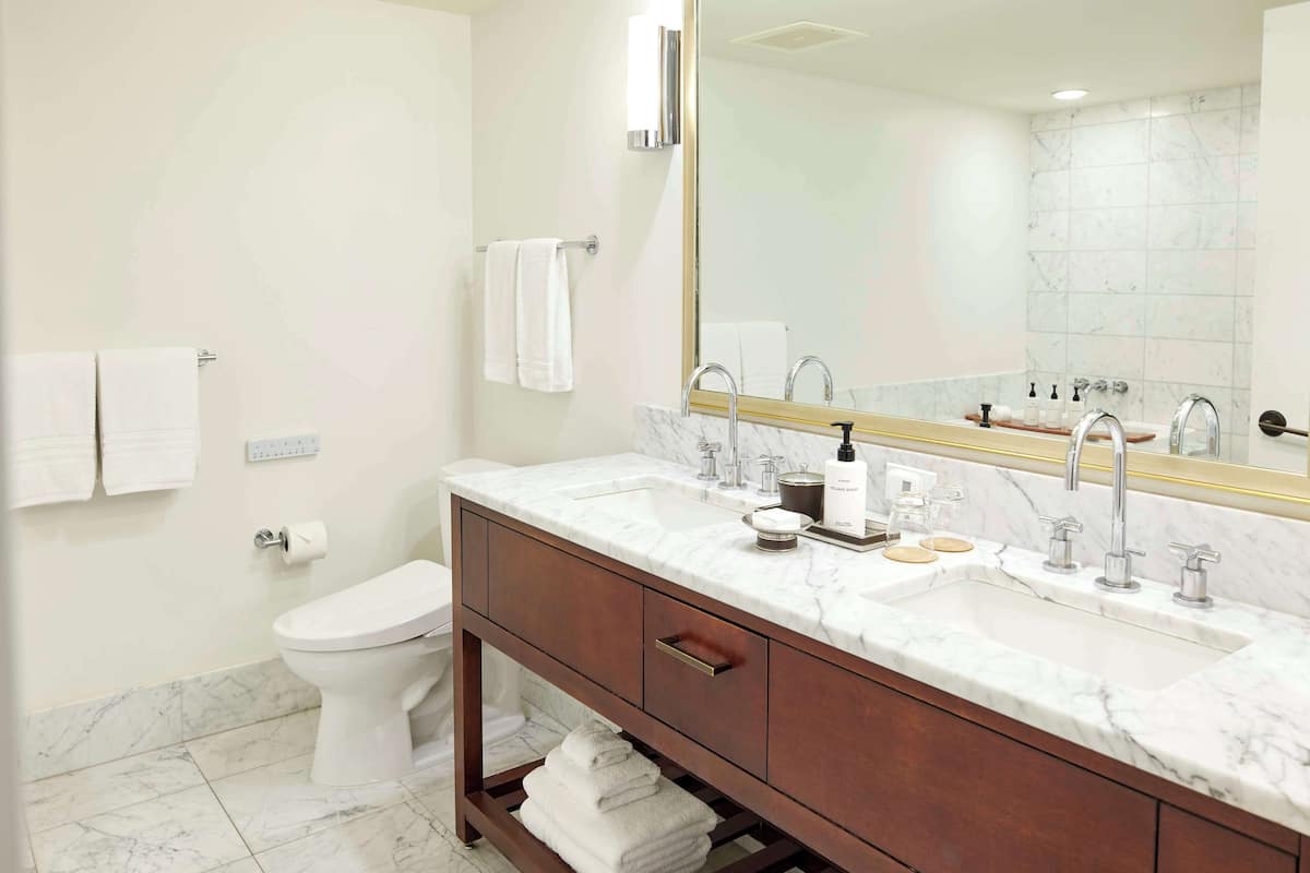 Deep soaking tub, designer toiletries, hair dryer, bathrobes