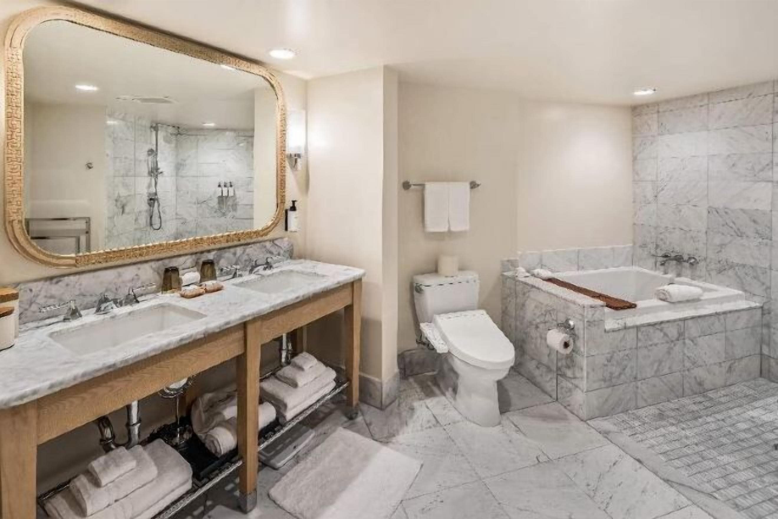 Deep-soaking bathtub, rainfall showerhead, designer toiletries