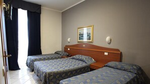 A hotel room with two single beds, a wooden headboard, a nightstand, a bedside table, a framed picture on the wall, and a window with curtains. - Arco Hotel (Milan)