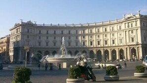 A historic building with a central fountain and statues, surrounded by a plaza with potted plants. - Domus Livia Luxury Suites (Rome)