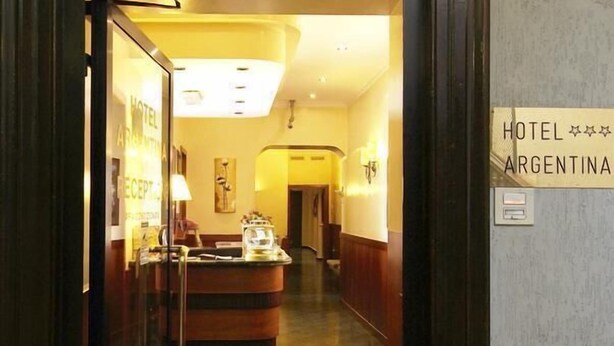 The entrance to Hotel Argentina with a reception desk and a sign indicating the hotel's name. - Hotel Argentina (Rome)