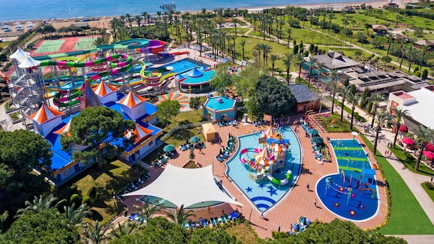An aerial view of a resort with a water park, pool areas, and a beach. - IC Hotels Green Palace & Villas - All inclusive (Antalya)