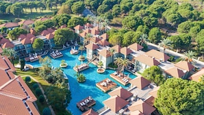 An aerial view of a resort with multiple swimming pools, villas, and lush greenery. - IC Hotels Green Palace & Villas - All inclusive (Antalya)